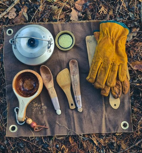 A close-up image of a selection of wooden tools on a light-colored cloth