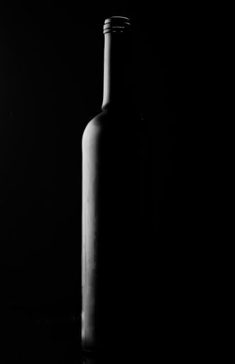 A minimalistic shot of a wine bottle silhouette on black background
