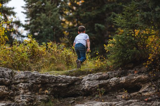 A boy playing in Big Hills Springs Provincial Park in Alberta, Canada