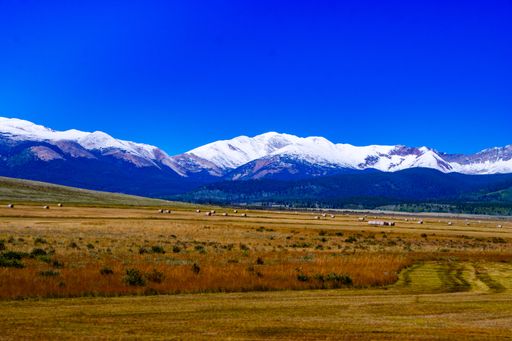 An awe-inspiring view of snow-capped mountains against the background of blue sky. Crested Butte