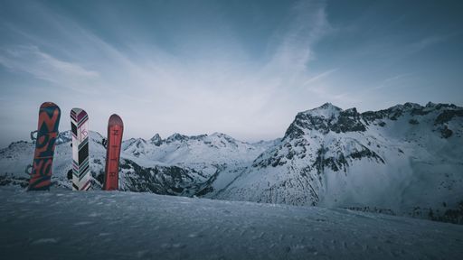A close-up of a snowboarder skis resting on a snowy surface in Austrian Alps
