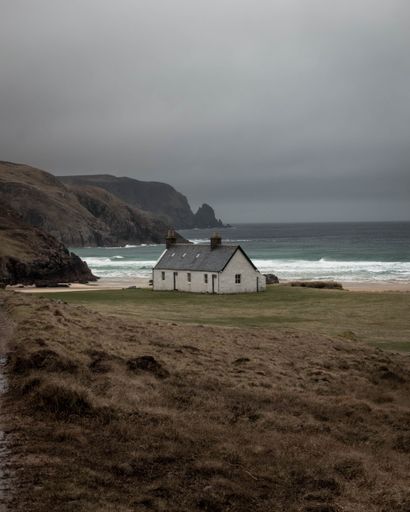 A vertical shot of the quaint Kearvaig Bothy in the remote far north of Scotland