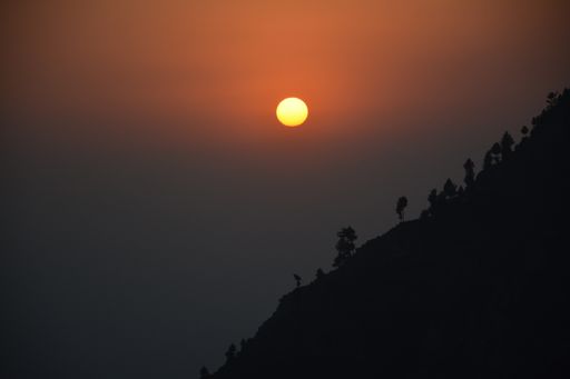 this is a picture of the Sun setting behind a hill in Swat, Pakistan