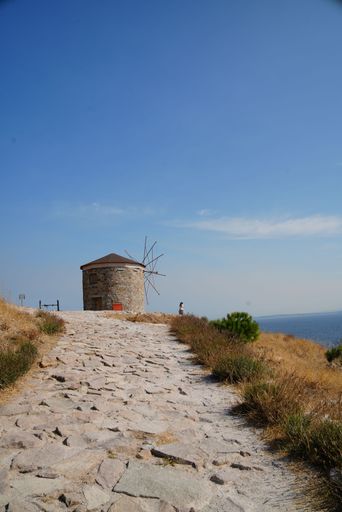 A scenic view of windmills at the top of the island in Canakkale, Bozcada