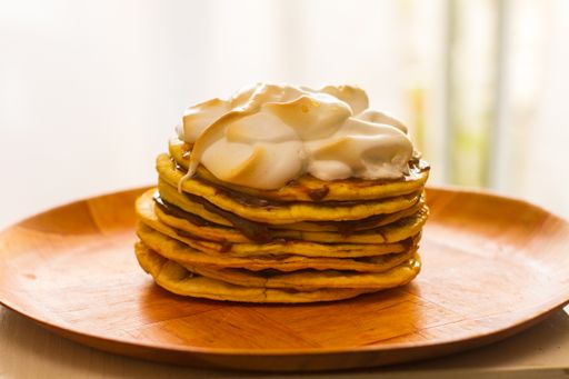 A wooden plate with pancakes