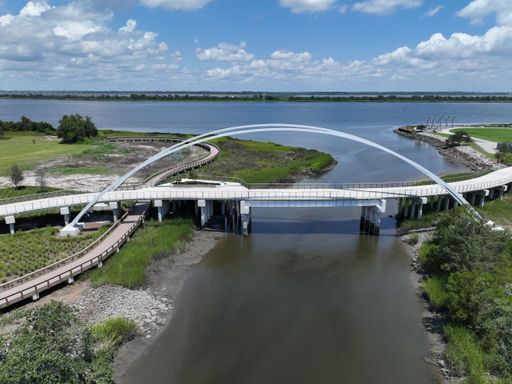 A scenic view of a bridge arching over a body of water, North Charleston Park