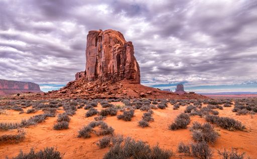A breathtaking view of Monument Valley in Arizona with colorful sky at sunrise.