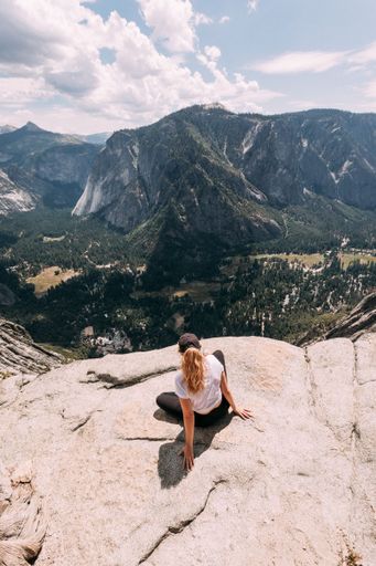 A scenic view of a female hiker on a rock at Joshua Tree National Park, California