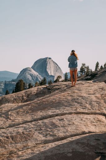 A scenic view of a female hiker on a rock at Joshua Tree National Park, California