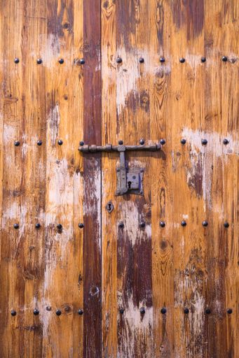 A vertical shot of an old wooden door