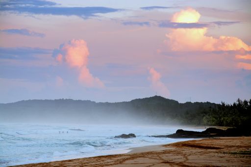 A misty beach in Puerto Rico with pink and purple clouds in the sky above