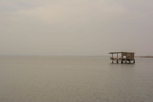 A picturesque dock situated on a body of water, with a boat tethered to it for mooring