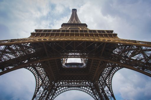 A low angle shot of Eiffel Tower Paris France with sky on the background