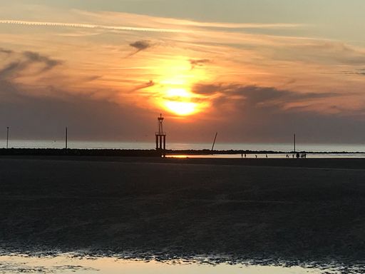 Stunning shot of a beautiful sunset over a tranquil beachside ocean