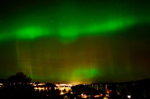 An idyllic night scene of Tromso, Norway featuring the stunning Northern Lights