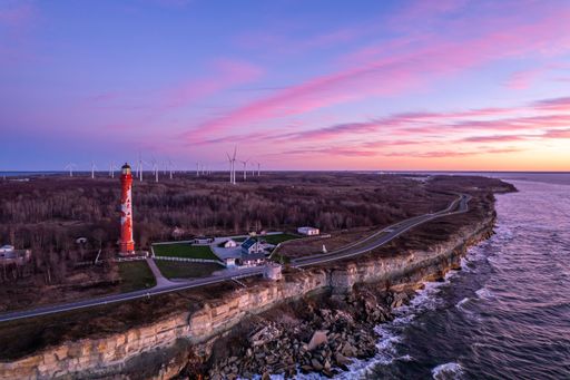 A picturesque view of a lighthouse in the Pakri Peninsula of Paldiski at sunset