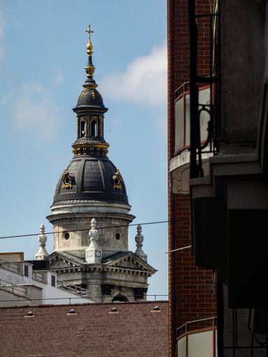 a vertical shot of St. Stephen's Basilica under a blue sky in Budapest, Hungary