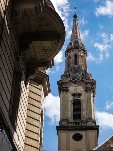 a vertical shot of Saint Francis church under a cloudy sky in Budapest Hungary