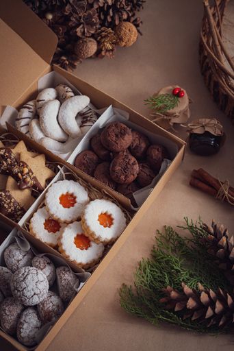 A top view of the freshly baked various types of sweet and tasty Christmas cookies in a box