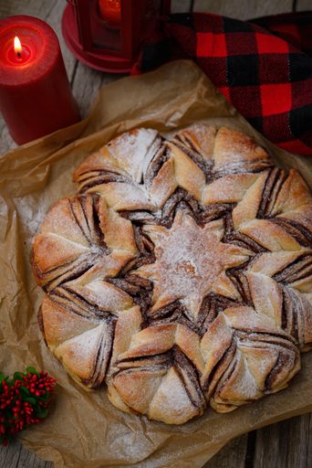 A top view of a freshly baked delicious pie covered in sugar powder