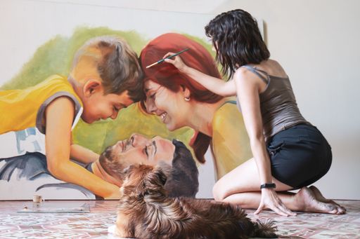 A shot of a Hispanic artist from Cuba painting on canvas