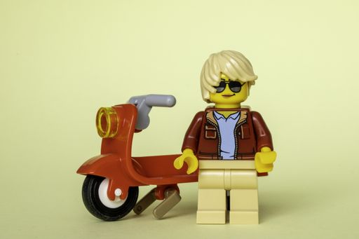 A Lego man with his red scooter