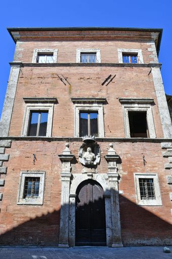 The facade of an old palace in a medieval village in Tuscany