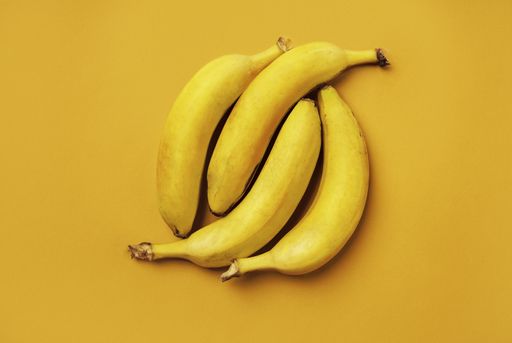A top view of bananas isolated on the yellow background