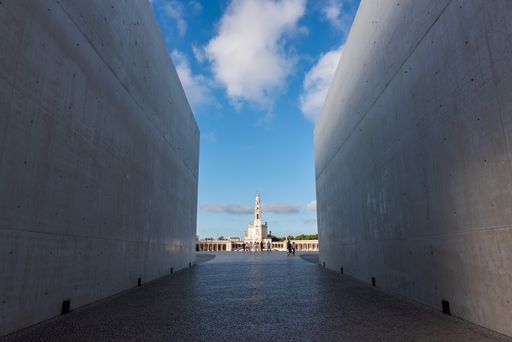 A wide angle shot of a building seen through two large walls in Portugal