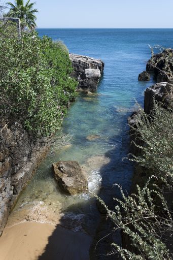 A vertical shot of an exit to the sea through the cliffs, Cascais, Portugal