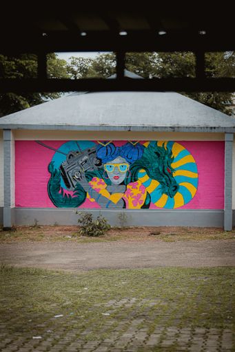 A vibrant mural of graffiti art adorning the side of a suburban building
