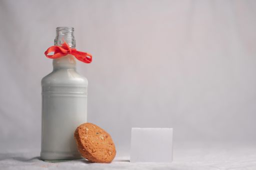 cookies and bottle of milk on white background food