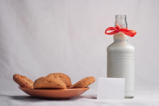 cookies and bottle of milk on white background food