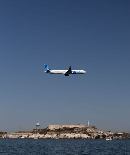 United Airlines Boeing 777 flying low over Alcatraz Island in San Francisco during a Fleet Week Air show demonstration
