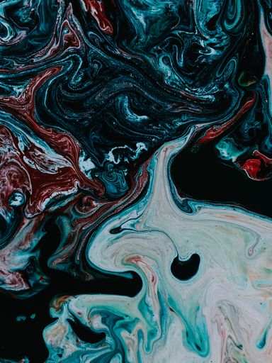 A vertical shot of an abstract painting with mixed dark oily colors - perfect for wallpaper
