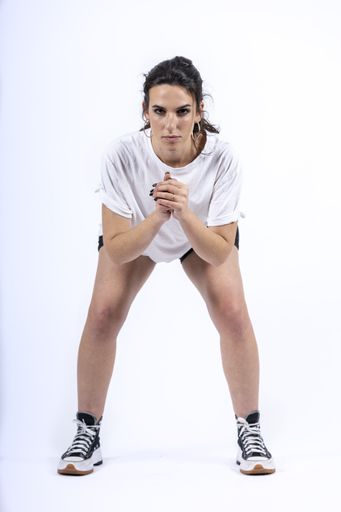 An attractive young Hispanic female doing squat