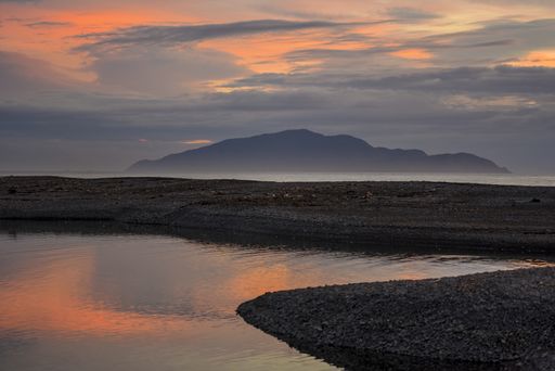 The Otaki river with Kapiti island in the background at scenic sunset