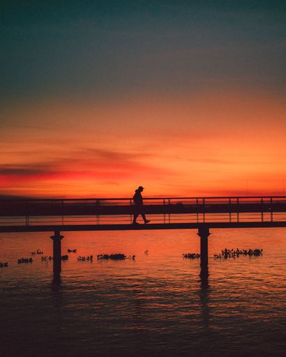 A man walking across the iconic bridge of Lake Guaiba in the southern part of Brazil
