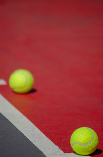 A close-up view of tennis balls on the court during a match