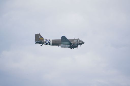 A jet flying in the sky on a cloudy day