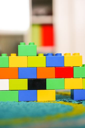 Small colorful wall made of Lego Duplo blocks on a floor