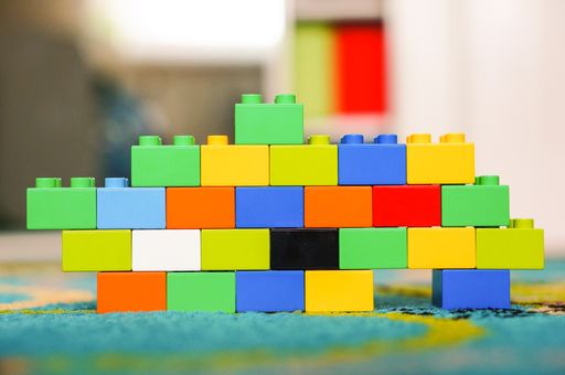 Small colorful wall made of Lego Duplo blocks on a floor
