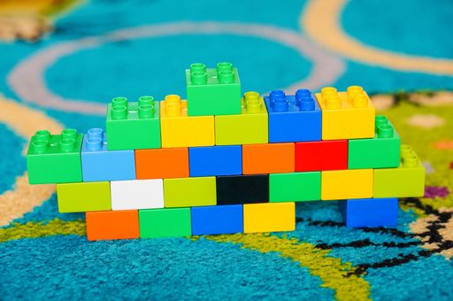 Small colorful wall made of Lego Duplo blocks on a floor