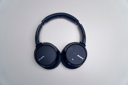 A top view of a dark blue Sony over-ear headphones isolated on a gray background
