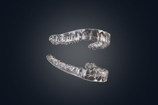 Clean transparent silicone orthodontic braces for aligning the denture isolated on black