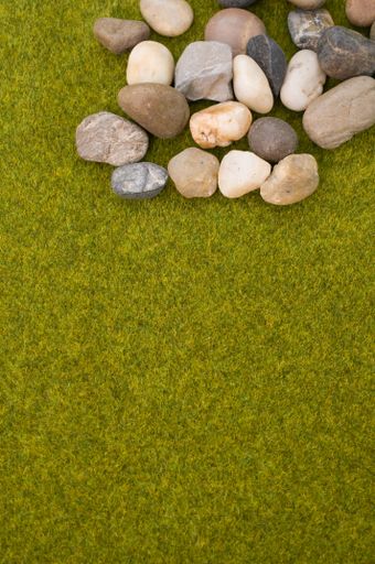 A vertical shot of cobbles on the green grass background
