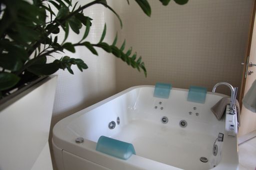 The interior of a modern bathroom with a bathtub