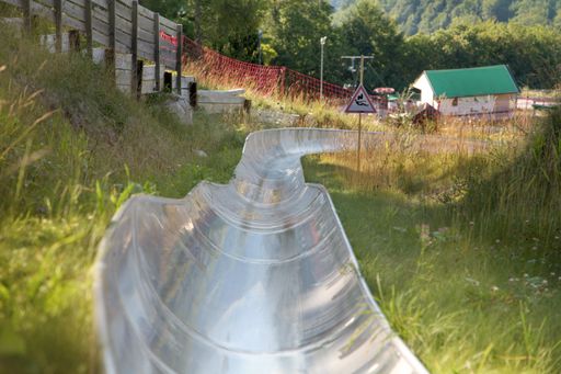 A slide in a green field in a rural area