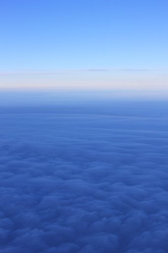 A tranquil scenery of the sunrise above the blue clouds for background or wallpaper