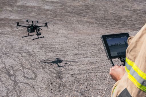 Cool firefighting rescue drone and a man holding the controller